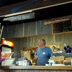 Christopher behind the counter helping another customer