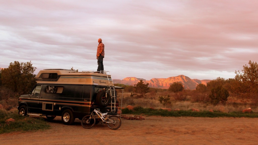 John stands on his van to get a view of the land